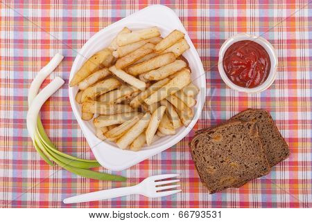 Fried Potatoes In A Plate On A Tablecloth.
