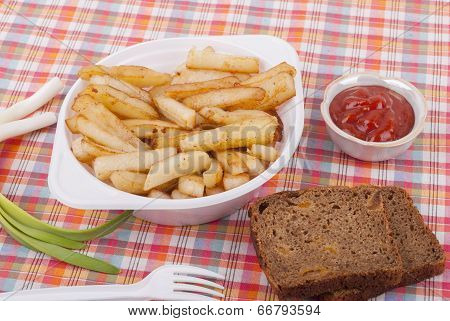 Fried Potatoes In A Plate On A Tablecloth.