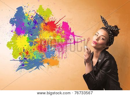 Cute girl blowing bubble spalsh graffiti into wall