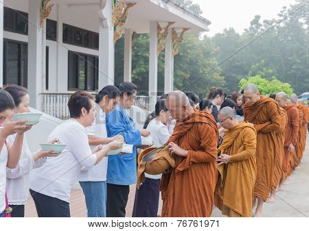 People Put Food Offerings In A Buddhist Monk's Alms Bowl To Make Great Merit
