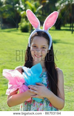Smiling Happy Teen Girl With Rabbit Ears And Easter Chocolate Eggs