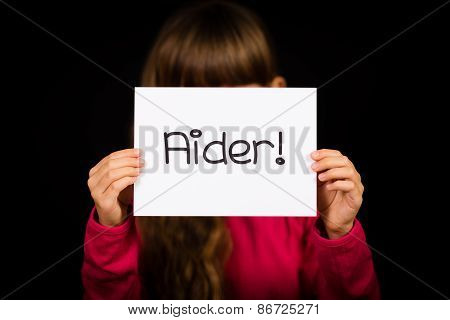 Child Holding Sign With French Word Aider - Help