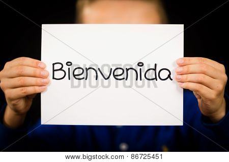 Child Holding Sign With Spanish Word Bienvenida - Welcome