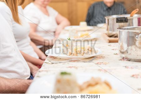 Family Sitting And Having A Dinner