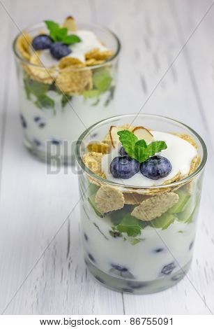 Yogurt Dessert With Blueberry, Kiwi And Cereals In The Glass