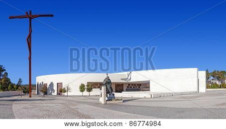 Sanctuary of Fatima, Portugal, March 07, 2015 - Basilica of Most Holy Trinity with Statue of Pope John Paul II and the new High Cross. Fatima is a world major pilgrimage location for Catholics