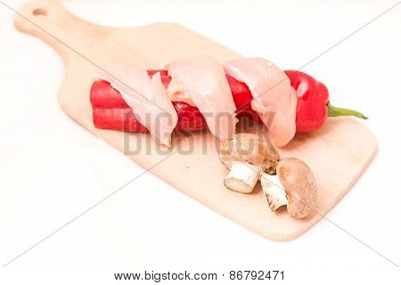 Sliced chicken breast with mushrooms, peppers for cooking