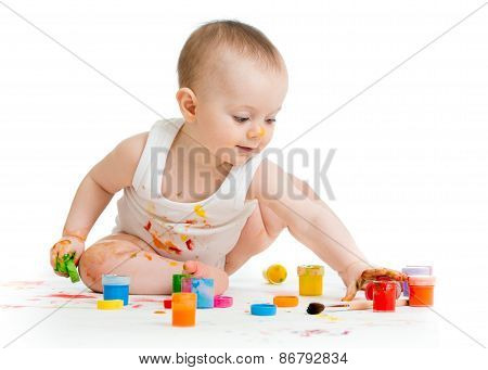 Little baby paint by his hands - on white background