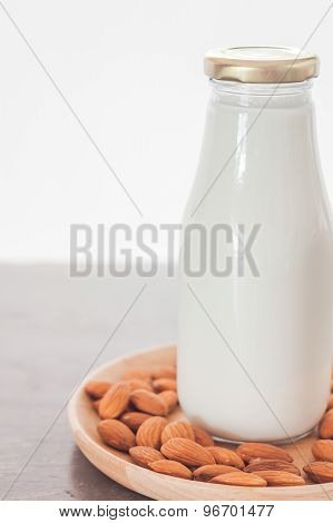 Almond Nuts On Wooden Plate With Milk