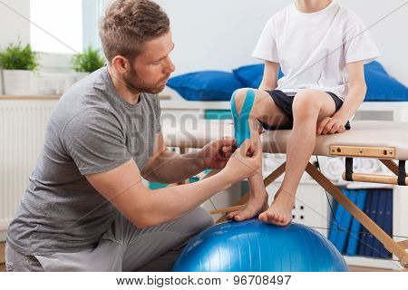 Physical Therapist Applying Medical Tape