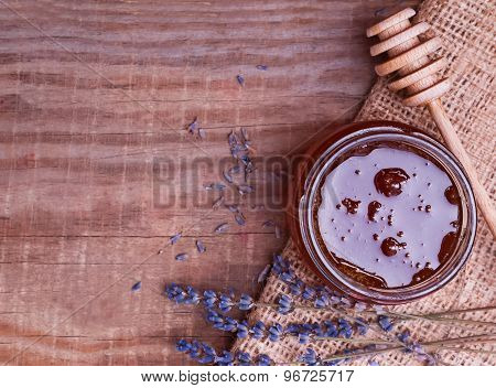 Honey In A Glss Jar And Lavender Flowers On The Wooden Table