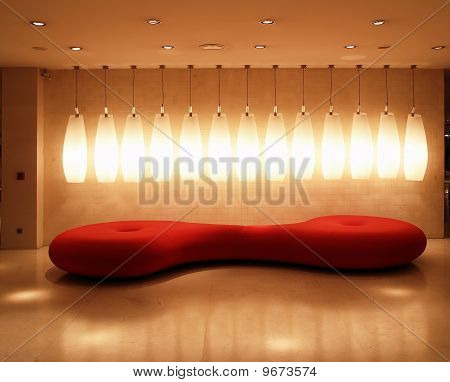 Ambiente interno rosso con luce e divano