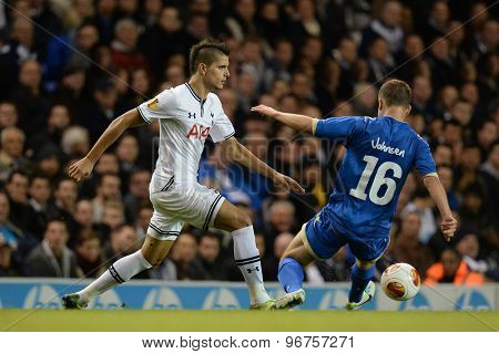 LONDON, ENGLAND - September 19 2013: Tottennham's Erik Lamela and Tromso's Lars Gunnar Johnsen during the UEFA Europa League match between Tottenham Hotspur and Tromso played at The White Hart Lane