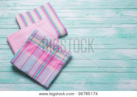 Pink  Kitchen Towels  On Turquoise  Wooden Background.