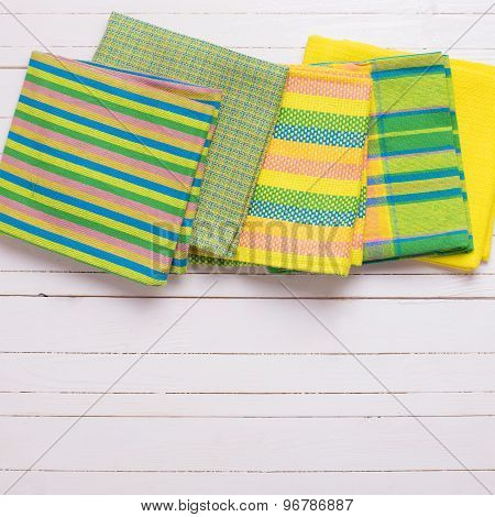 Yellow  Kitchen Towels  On White Wooden Background.