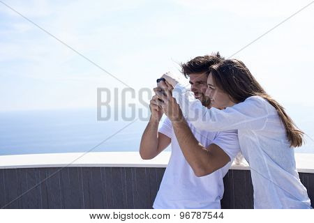 happy young couple taking selfie with cell phone