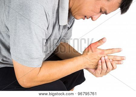 Man with painful and inflamed gout on his hand around the thumb area.