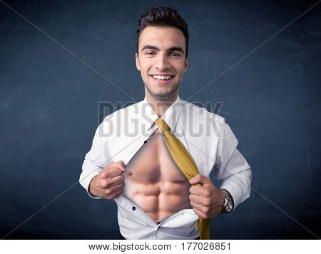 Businessman tearing off his shirt and showing mucular body concept on background