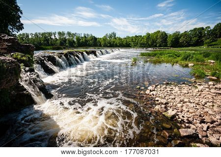 Mountain River In Summer Surrounded By Forest