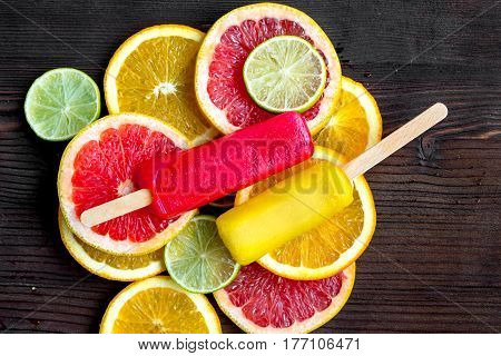 Homemade orange icecream with fresh fruits on wooden table background top view