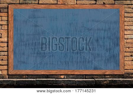 Chalkboard wood frame with black surface on old vintage brick wall background blackboard texture with copy space for educational or business background.