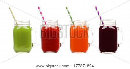 Four Mason Jar Glasses Of Vegetable Juice, Greens, Tomato, Carrot And Beet, Isolated On A White Back