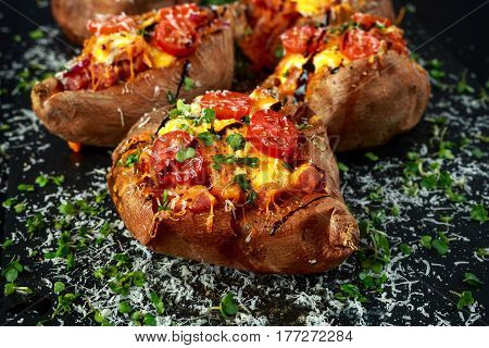 hot baked sweet potato stuffed with bacon, cheddar cheese, cherry tomatoes, balsamic vinegar, cress salad and parmesan sprinkle. Tacco, burrito style