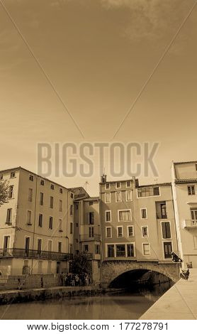 Narbonne, France - October 8, 2016; Canal de la Robine through center of city with surrounding scenes and Merchants Bridge streets scenes and architecture Narbonne France.