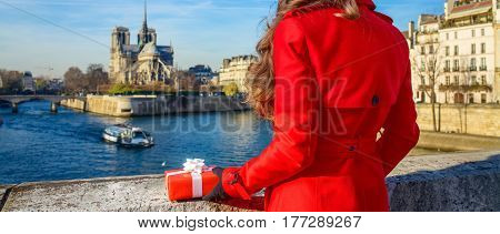 Seen From Behind Woman In Paris With Christmas Present Box