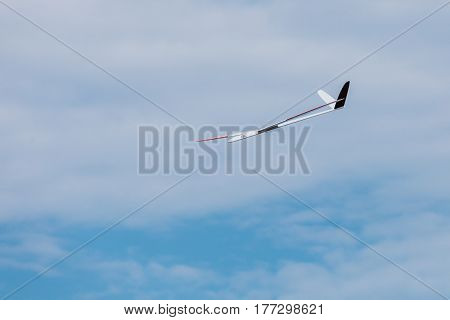 RC remotely controlled soaring plane model sailplane on blue sky in brisk wind