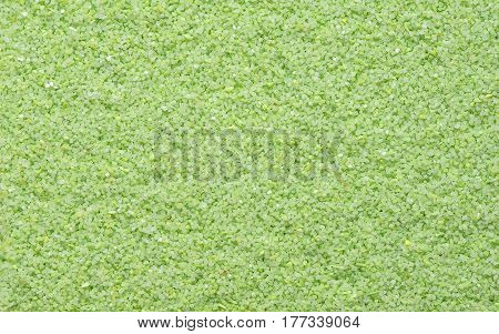 Green sand texture. Green sand. Background from fine sand. Green sand background