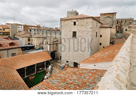 Avila Spain - November 11 2014: The Medieval Walls of Avila and the cathedral. Cloudy day. The old city and its extramural churches were declared a World Heritage site by UNESCO