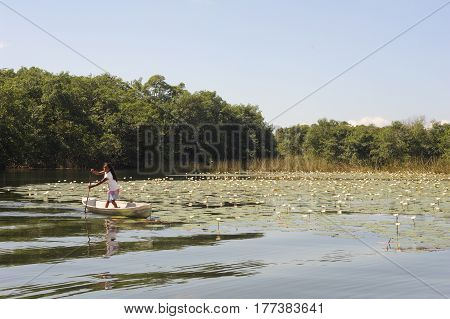 Girl On Canoe At Isla De Las Flores On River Dulce