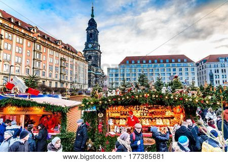 DRESDEN SAXONY / GERMANY - 17 DECEMBER 2016: People visit Christmas Market Striezelmarkt in Dresden Germany. Christmas fair European traditions.