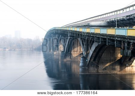 Railway ridge over the river in the fog sunny day