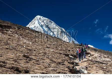 Trekker approaching PumoRi mountain in Khumbu valley on a way to Everest Base camp