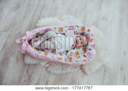 Photo Charming Newborn Baby In A Pink Cradle
