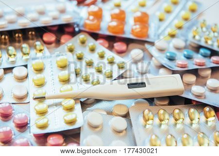 Flu. Thermometer With Elevated Temperature And Many Pills On Light Background