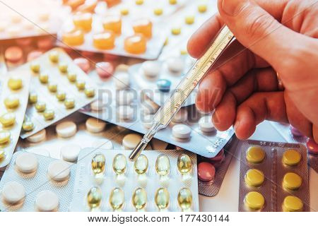 Thermometer And Different Colored Types Of Pills. Medical Health Or Drugs Concept