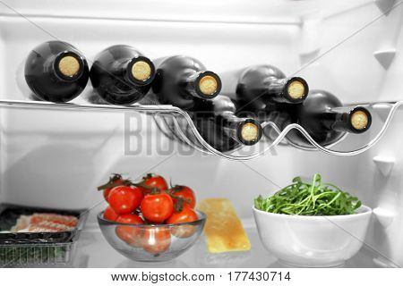 Wine bottles and products in refrigerator