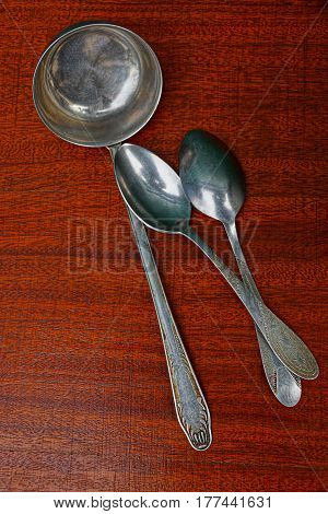 Iron ladle and spoon on red table