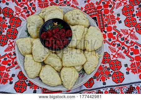 Homemade dumplings and preserving of cherries on a towel