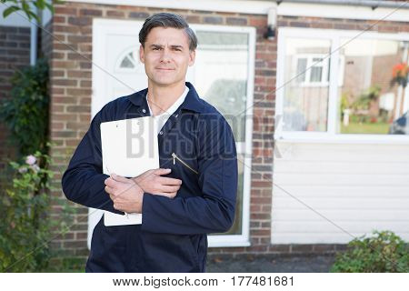 Portrait Of Workman Preparing Estimate For Work On House