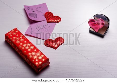 Wooden White Background With A Branch Of Pine And Three Hearts.