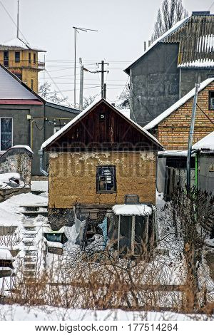 Old private house and a winter yard on the street