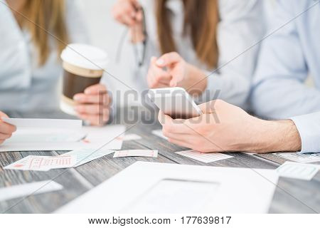 A group of people designers designing a wireframe application of mobile phone and responsive websites. Teamwork and user experience.