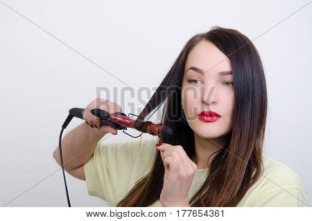 a girl does a hair-do a rectifier for hair
