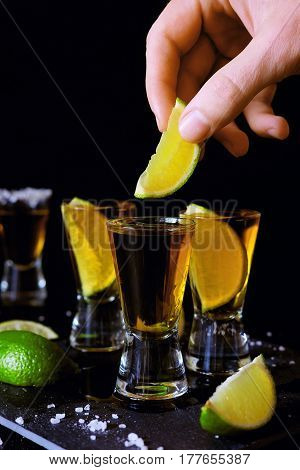 Strong alcohol drinks. Tequila glass shots in the bar with salt and lime slices.