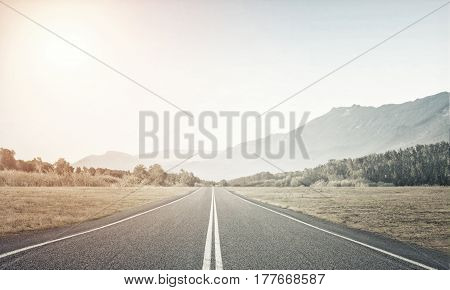Natural summer landscape with asphalt road to horizon