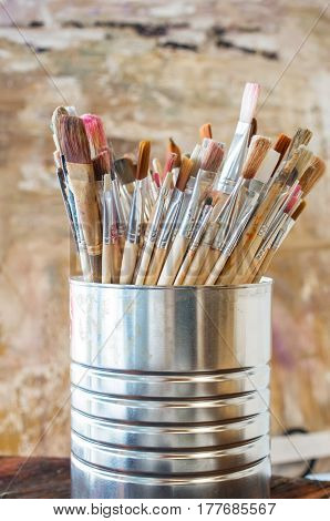 Artist Paint Brushes. Used kit paint brushes in can. Close-up.